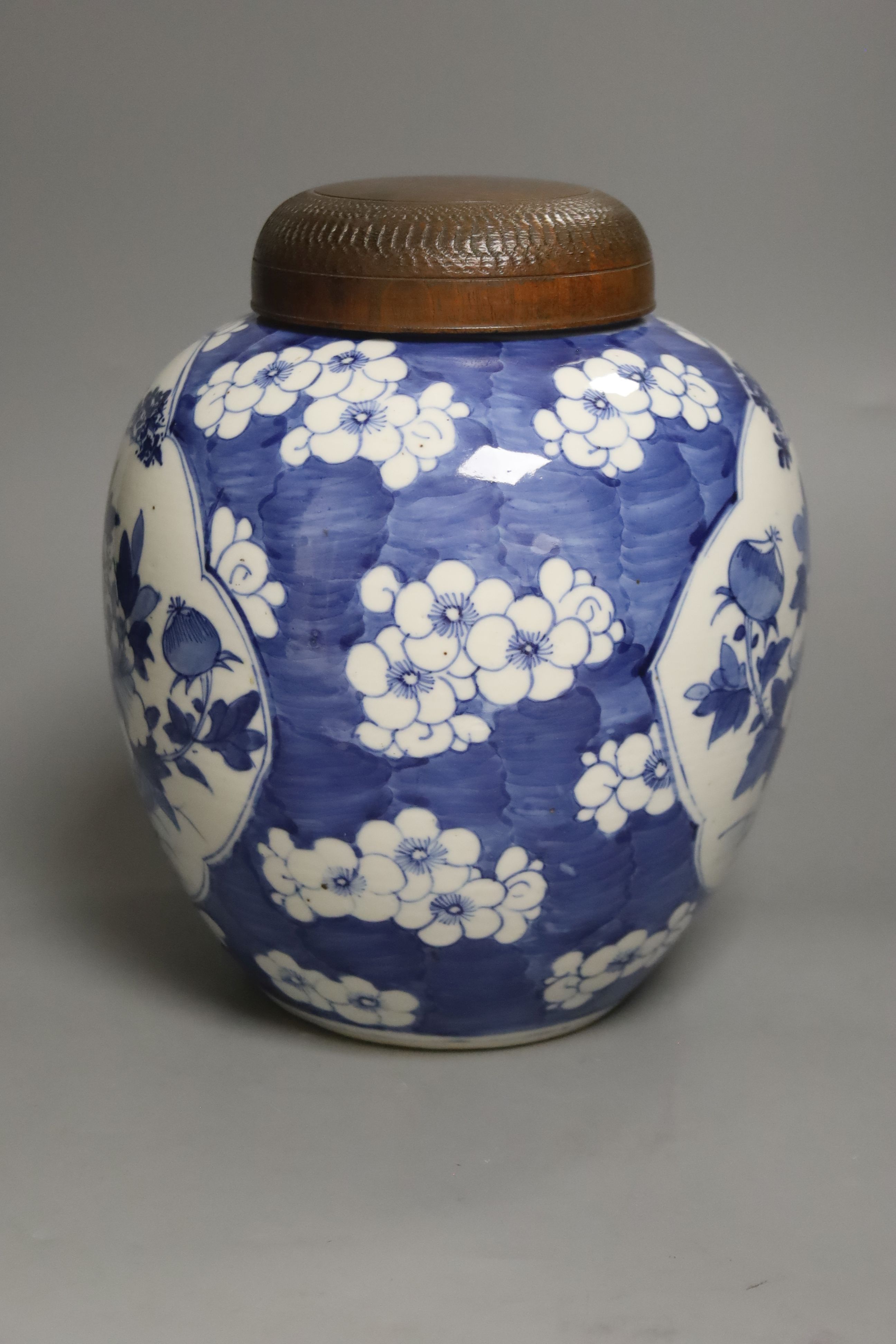 A late 19th / early 20th century Chinese blue and white jar, with wooden cover, height 25cm